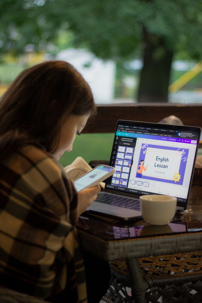 Mastering the First Impression: Your intriguing post title goes here Woman using laptop for online English lesson while checking her phone.
